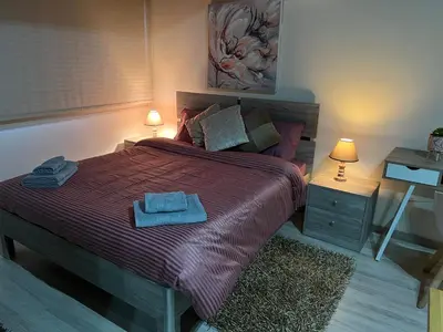 a bedroom with a bed with two towels on it at Ellados 20 in Limassol