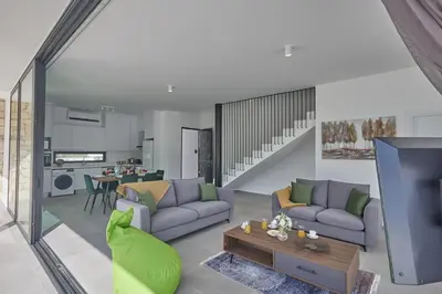 a living room with two couches and a tv at Protaras Elite Pearl Ville Ep3c in Protaras