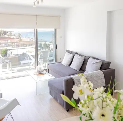 a living room with a couch and a view of the ocean at Seaview Apartment (Excellent Location) in Larnaka