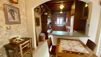 a kitchen and dining room with a table and a counter at Juliet Suite by TrulyCyprus in Doros