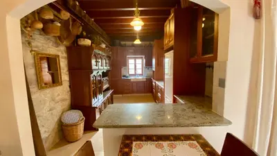 a kitchen with a island in the middle of a room at Juliet Suite by TrulyCyprus in Doros