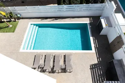 an overhead view of a swimming pool with two lounge chairs at Luxury Panorama Villa Protaras in Protaras