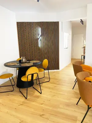 a dining room with yellow chairs and a table at Luxury City Retreat- 2-Bedroom, 2-Bath Apartment in Nicosia