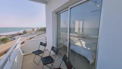 a balcony with chairs and a view of the ocean at STAY Beach Wave Apartment in Larnaka