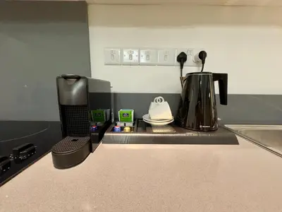 a kitchen counter with a coffee maker on a counter top at Panorama Residence in Nicosia