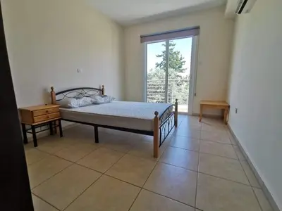 a bedroom with a bed and a window at Mythical Sands BG03 townhouse in Paralimni