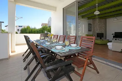 a dining room table with chairs and a tableastery at Villa Sea Horizon in Protaras