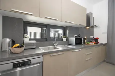 a kitchen with a sink and a microwave at Villa Daniella in Protaras