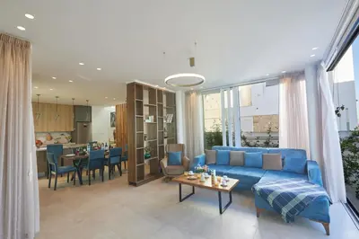 a living room with a blue couch and a table at Protaras Vie Bleu Villa Vb8 in Protaras
