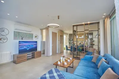 a living room with a blue couch and a tv at Protaras Vie Bleu Villa Vb8 in Protaras