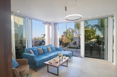 a living room with a blue couch and a table at Protaras Vie Bleu Villa Vb8 in Protaras