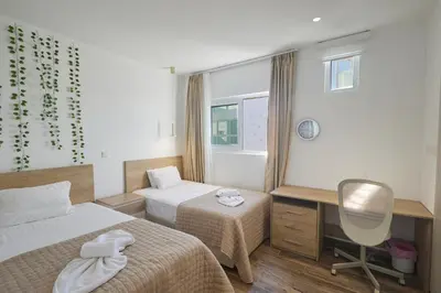 a bedroom with two beds and a desk and a chair at Protaras Vie Bleu Villa Vb8 in Protaras