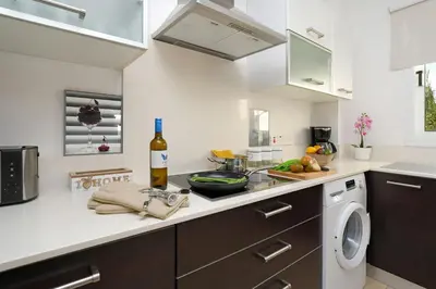 a kitchen with a counter with a bottle of wine at Villa Crystalia - 350m from Kalamies Beach in Protaras