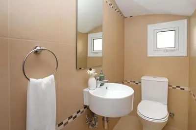 a bathroom with a sink and a toilet and a mirror at Villa Crystalia - 350m from Kalamies Beach in Protaras