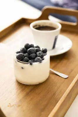 a bowl of blueberries and a cup of coffee at Villa Orchard by Tangerine in Protaras