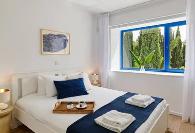 a bedroom with a bed with towels and a window at Villa Orchard by Tangerine in Protaras