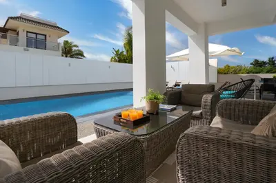 a patio with wicker furniture and a swimming pool at Villa Indigo in Protaras
