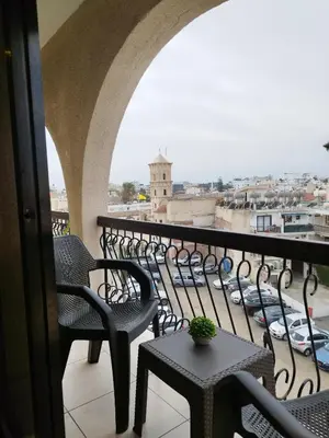 a balcony with chairs and a table and a view at 303 St Lazaros View Studio in Larnaka