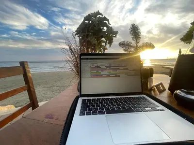a laptop computer sitting on a table on the beach at Glabur Stays! The One -1 - Elite Marina Front! in Zygi
