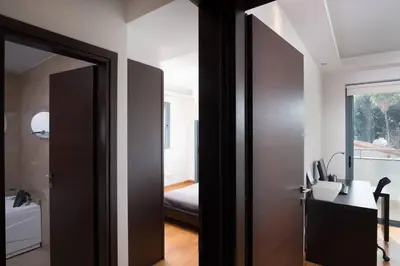 a door leading into a room with a bedroom at Dios Ponte Finikoudes Beachfront in Larnaka