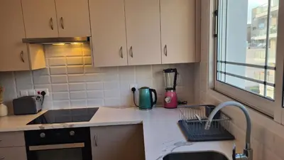 a kitchen with a sink and a counter top at STAY Sunlit Apartment in Limassol