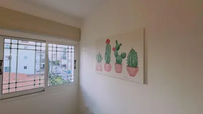 a room with three cactus posters and a window at STAY Sunlit Apartment in Limassol