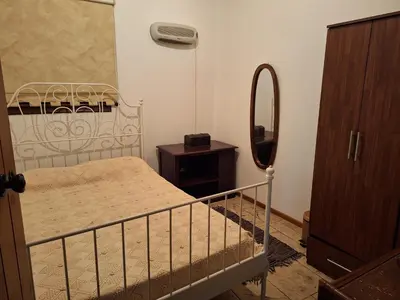 a small bedroom with a bed and a mirror at Koukaki in Kouka