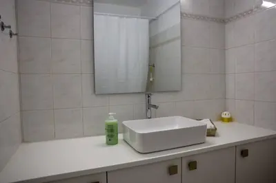 a bathroom with a white sink and a mirror at Cozy 2 Bdr Nicosia City Free Parking Wifi in Nicosia