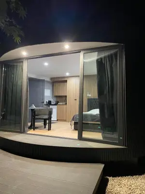 a room with sliding glass doors and a bedroom at River Glamping Kalopanayiotis in Kalopanayiotis