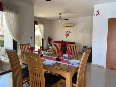 a dining room with a wooden table and chairs at Villa Ocean Breeze in Paralimni