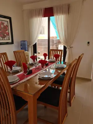 a wooden table with chairs and a dining room at Villa Ocean Breeze in Paralimni