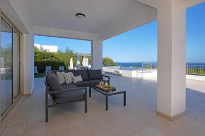 a living room with a couch and a table at Cape Panorama Villa in Protaras