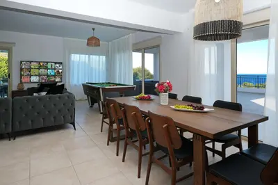a living room with a table and a pool table at Cape Panorama Villa in Protaras