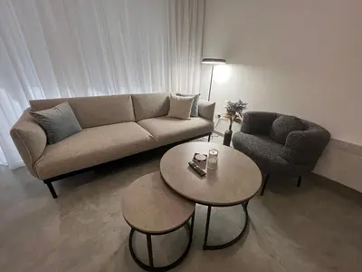 a living room with a couch and a table and a chair at Johnny's luxury getaway in Strovolos