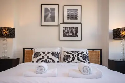 a bedroom with a bed with towels on it at Hallmark Beach by TrulyCyprus in Limassol