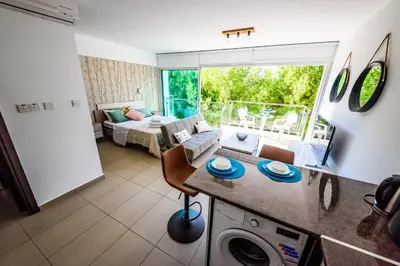 a kitchen and living room with a couch and a table at Studio in Protaras in Protaras