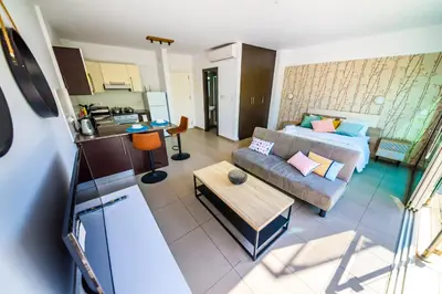 a living room with a couch and a bed at Studio in Protaras in Protaras
