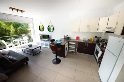 a kitchen and living room with a couch and a table at Studio in Protaras in Protaras