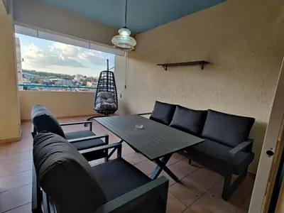 a living room with a couch and a table at Maestro II Apartment in Larnaka