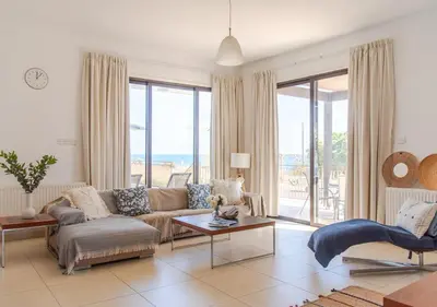 a living room with a couch and a table at Villa Hera in Ayios Theodhoros