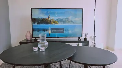 a living room with a table and a tv at STAY Cosmo City Suites in Nicosia