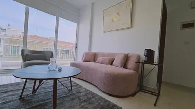 a living room with a couch and a table at STAY Cosmo City Suites in Nicosia