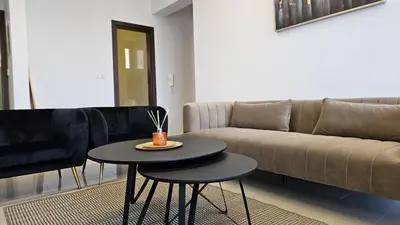 a living room with a couch and a table at STAY Cosmo City Suites in Nicosia