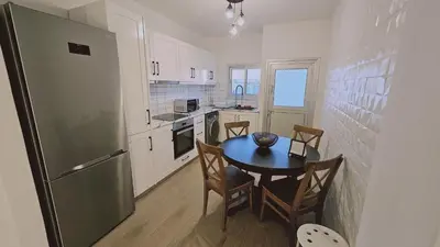 a small kitchen with a table and a refrigerator at STAY Sky Apartment in Limassol