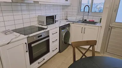a kitchen with a microwave and a stove top oven at STAY Sky Apartment in Limassol