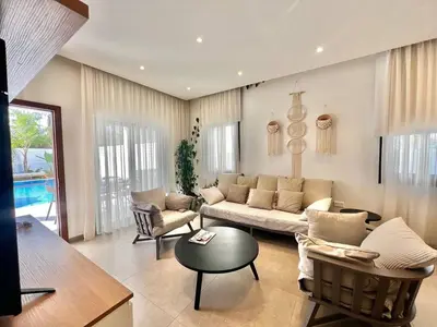 a living room with a couch and a table at Crystal-Blue-Villa Protaras in Protaras