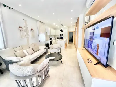 a living room with a couch and a tv at Crystal-Blue-Villa Protaras in Protaras