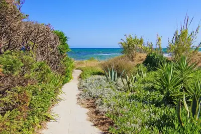 a path along the beach with the ocean in the background at Villa Posidonia - 200m from Sandy Beach in Ayia Napa