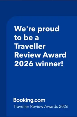 a blue sign that says were proud to be a traveller review award winner at Olive Garden's Paradise Villa in Skarinou