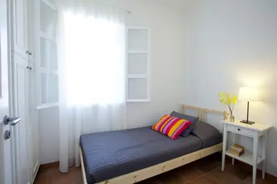 a small bed in a room with a window at Ayios Elias Pearl in Protaras